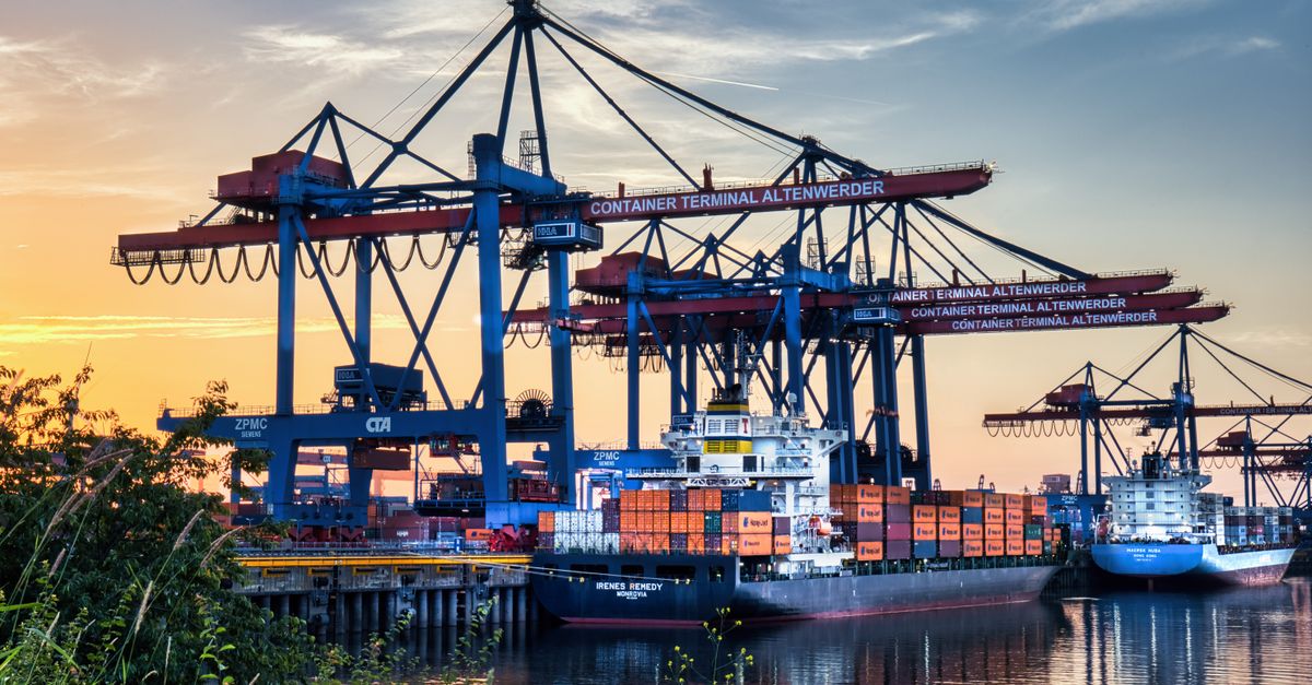 Industrial port with cargo ships and cranes at sunset, Container Terminal Altenwerder.