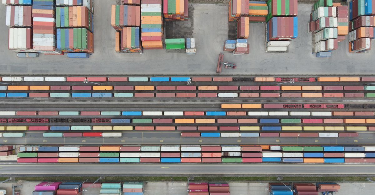 Aerial shot of stacked cargo containers at Regensburg port showcasing freight transport activity.